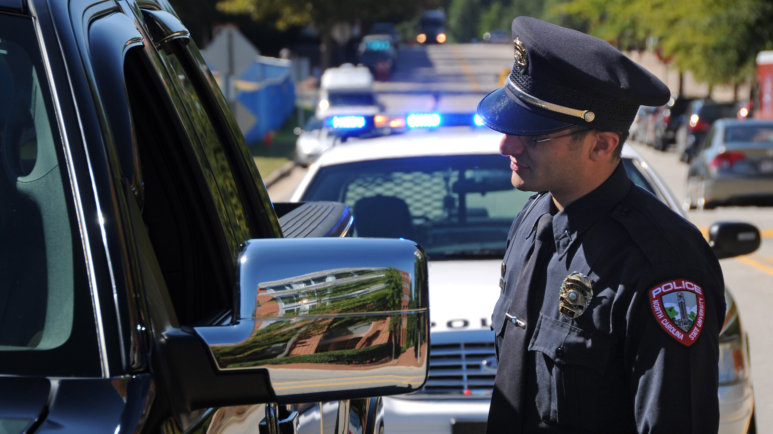 Campus police officer chats with a motorist on Centennial Campus.